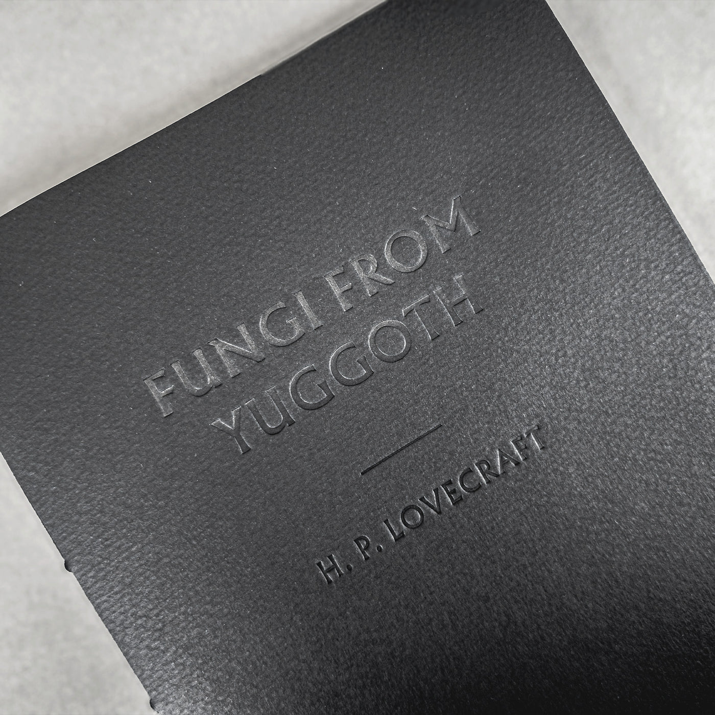 Fungi from Yuggoth letterpress pamphlet: black Fabriano Tiziano wrapper with the title and H. P. Lovecraft blind-debossed into the cover.