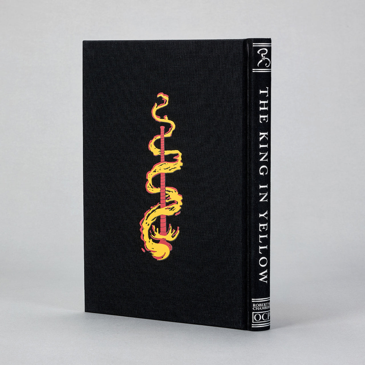 Back board of the King in Yellow Artefact Edition featuring Chambers' Yellow Sign in silver foil on black cloth.