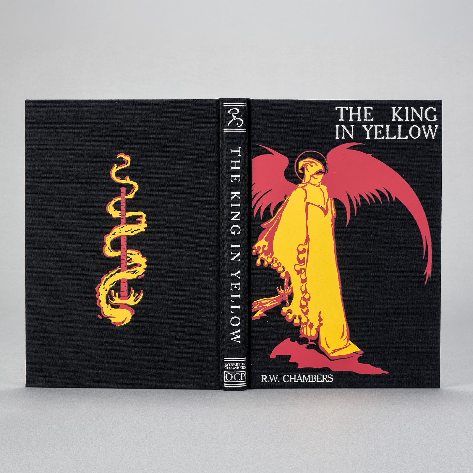 The King in Yellow Artefact Edition shown front and spine on a gray background — silver-foil title and red-and-gold cover figure.