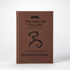 Companion volume — The King in Yellow: A Tragedy in Two Acts, a kraft-wrapped theatre booklet styled after late 19th-century printings.