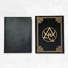 The Necronomicon Artifact Edition book (black PU leather with debossed border) and slipcase (black cloth with gold foil Necronomicon emblem and border)