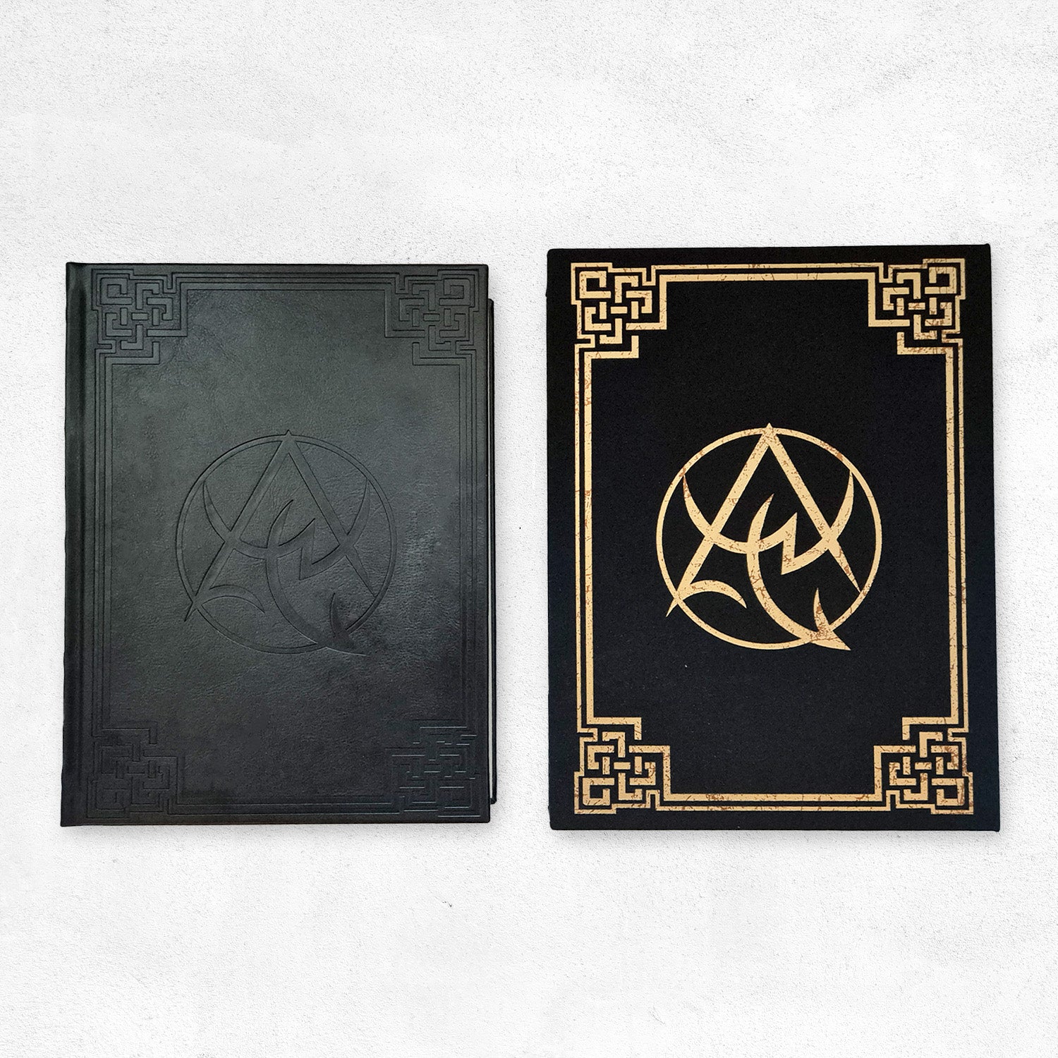 The Necronomicon Artifact Edition book (black PU leather with debossed border) and slipcase (black cloth with gold foil Necronomicon emblem and border)